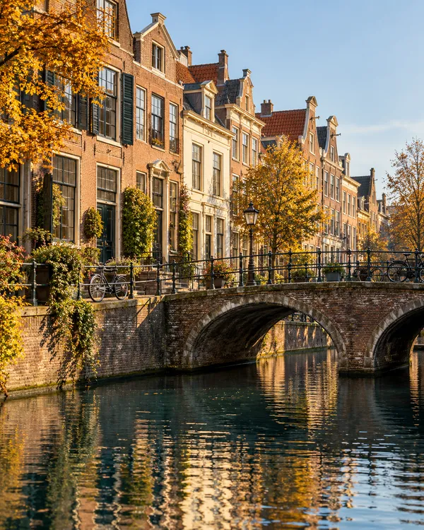 Atmospheric illustration of Dutch canal houses and a stone bridge